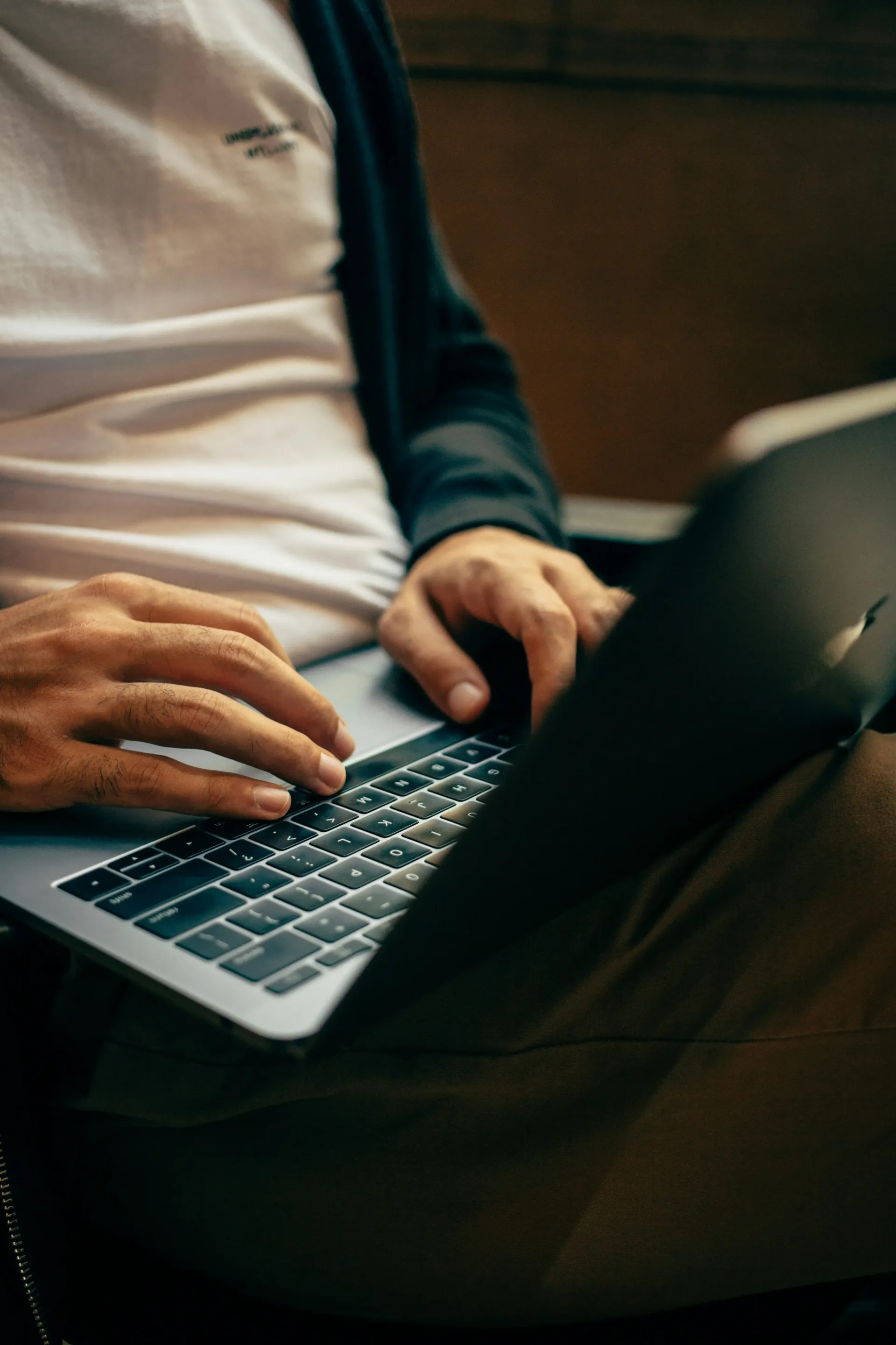 Hands typing laptop