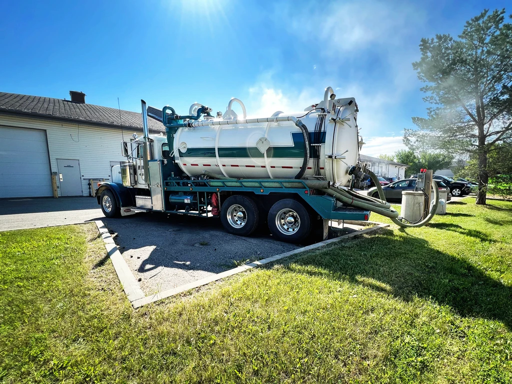 Vacuum truck from Rukus Liquid Waste Removal performing septic tank pumping and waste hauling service in Edmonton, Alberta.