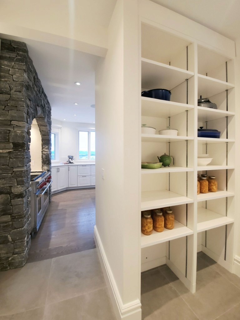 Image of KHD Homes kitchen design featuring white shelving unit with dishes and jars, modern layout and construction.