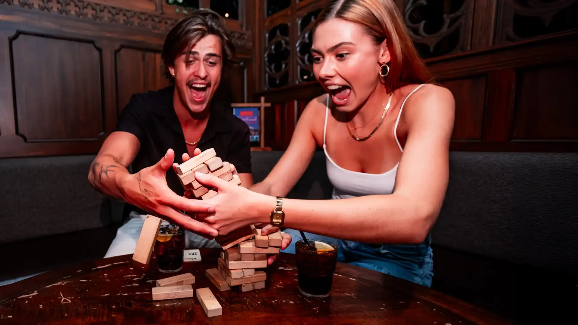 2 friends playing Jenga in the Fortress Tavern