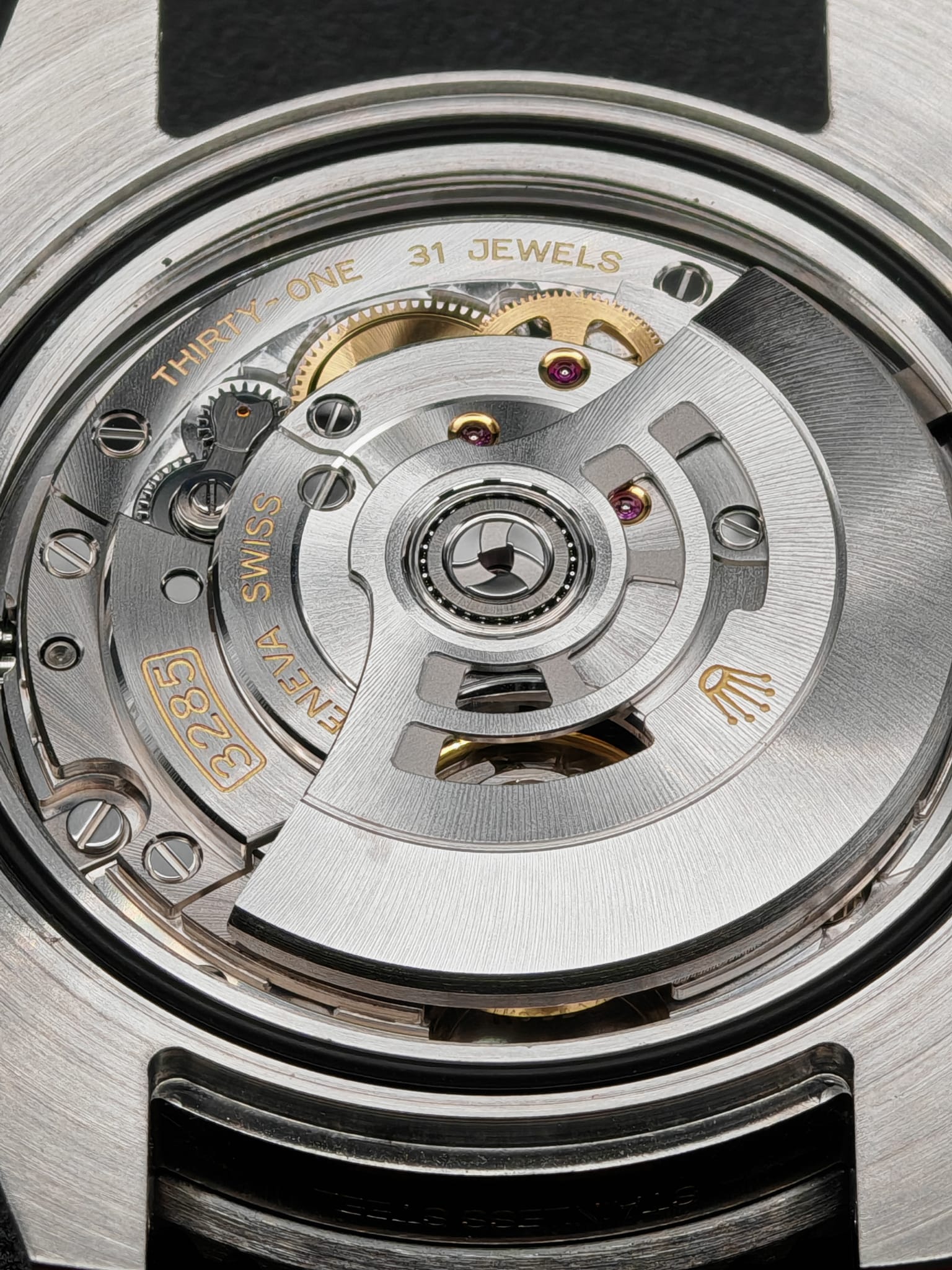 a close up of a watch on a black surface