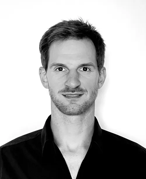 Mark, Level Events (custom trade show booth builders) co-founder in a dark collared shirt, smiling in a black and white image filter.