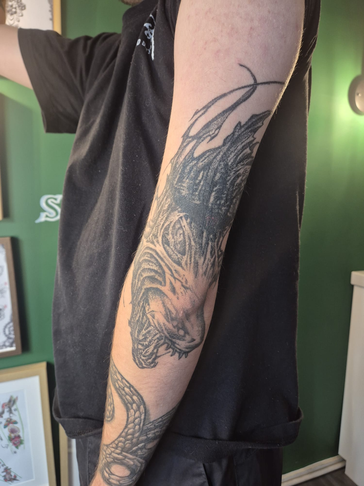 Lettering and symbol tattoo on inner forearm in Hazel Grove
