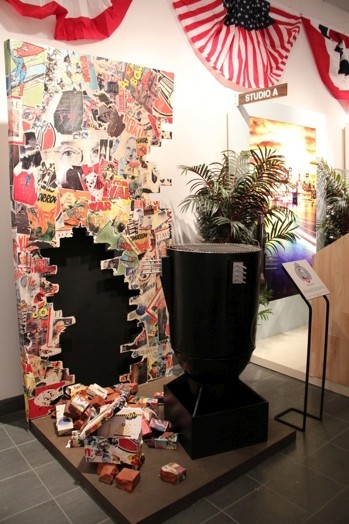 Stickers glued on a black wall, election decoration, and a black stand