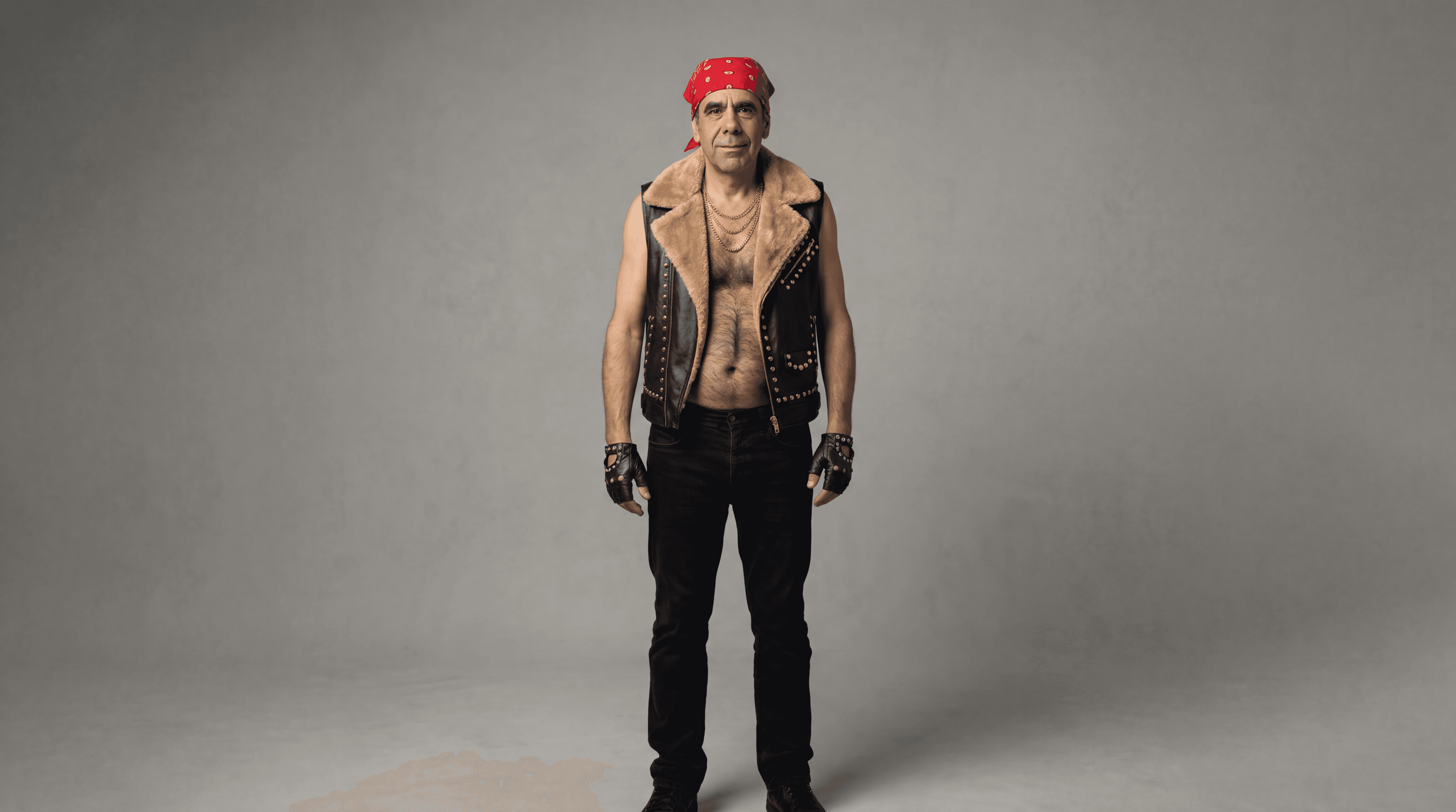 Wrestler wearing a red bandana against a neutral studio background