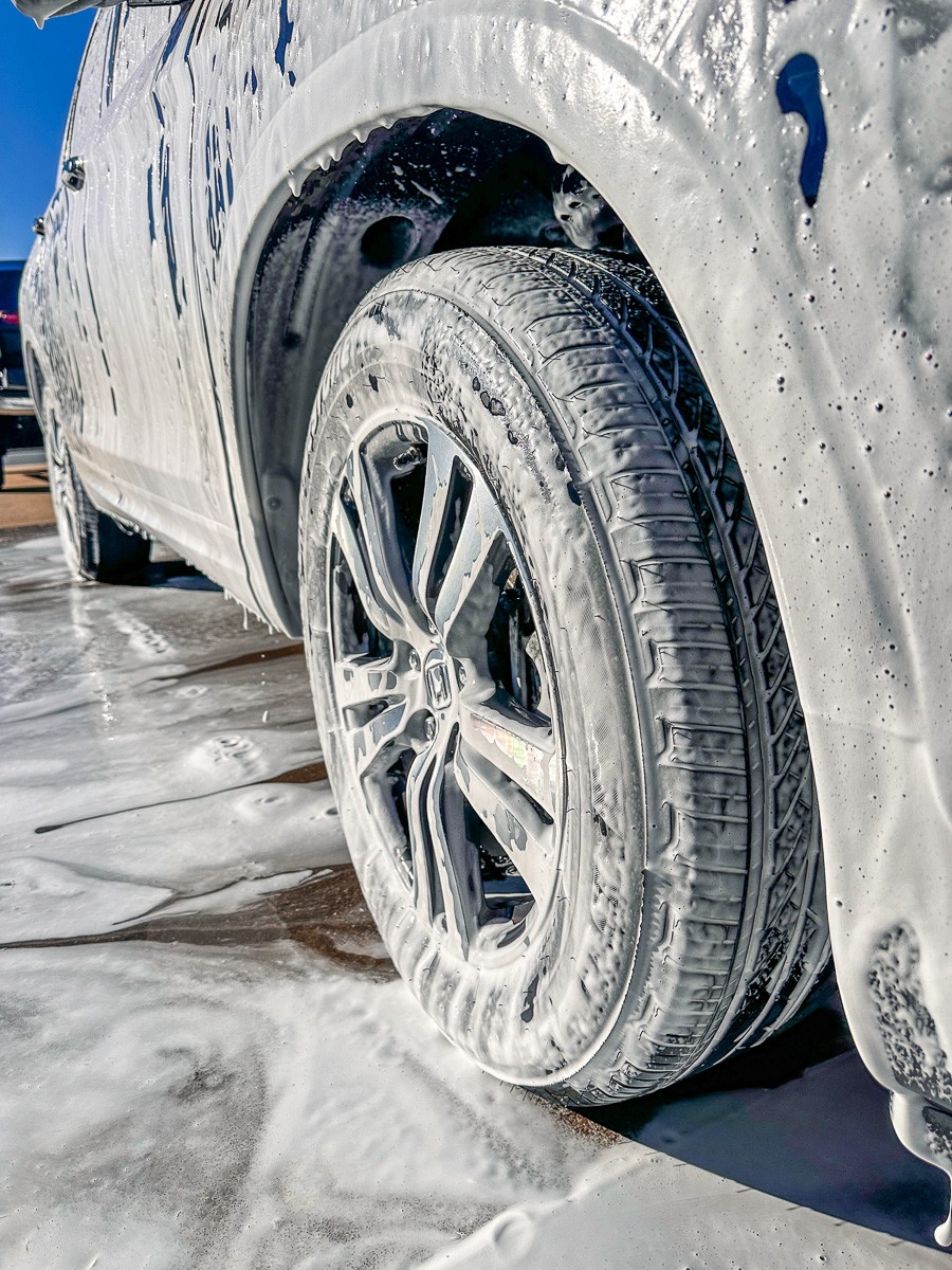 brown and white concrete house near green trees under blue sky during daytime