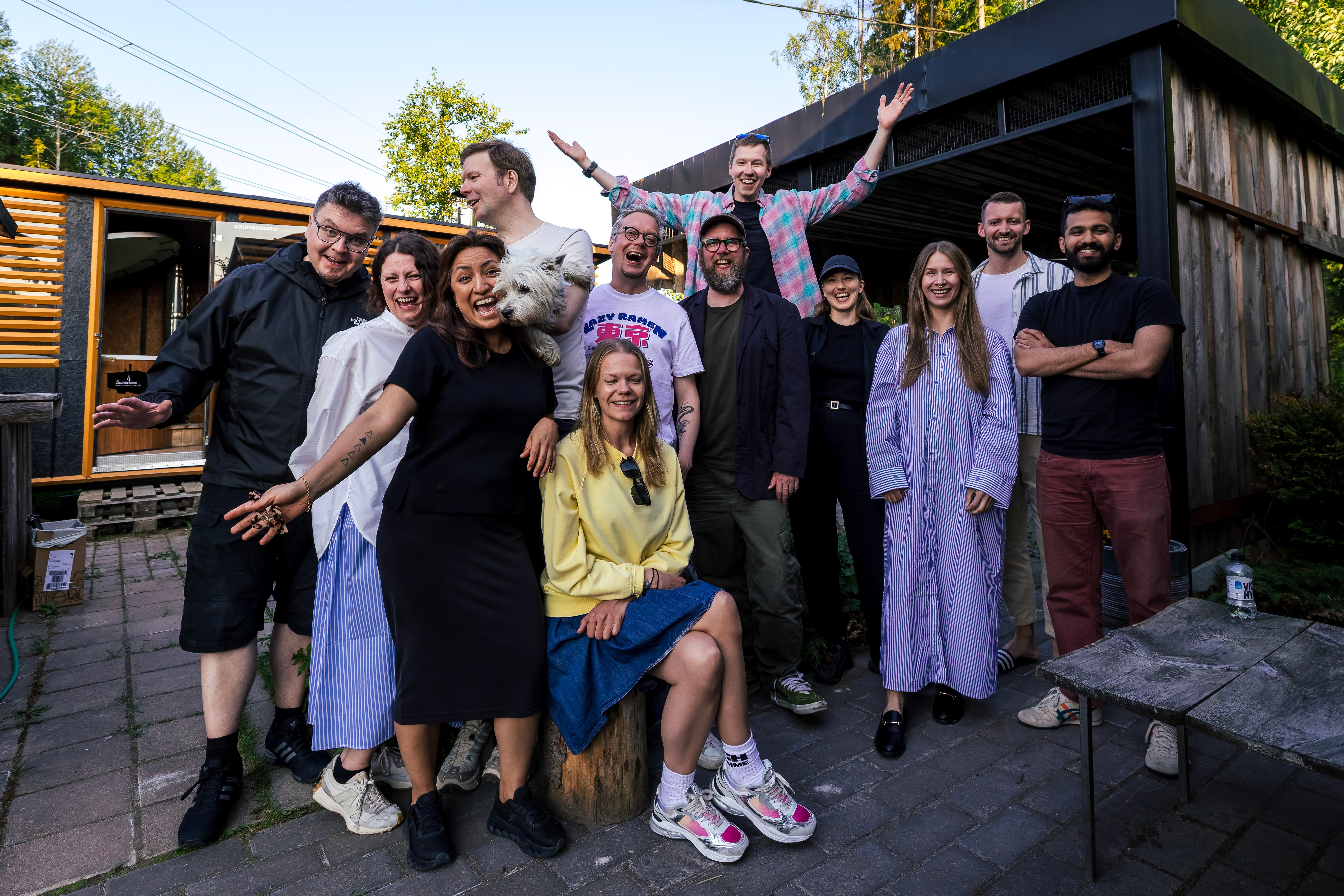 Black and white image of people working at a table with laptops, showing hands gesturing during discussion of digital content displayed on screens, with fabrica® logo in the corner.