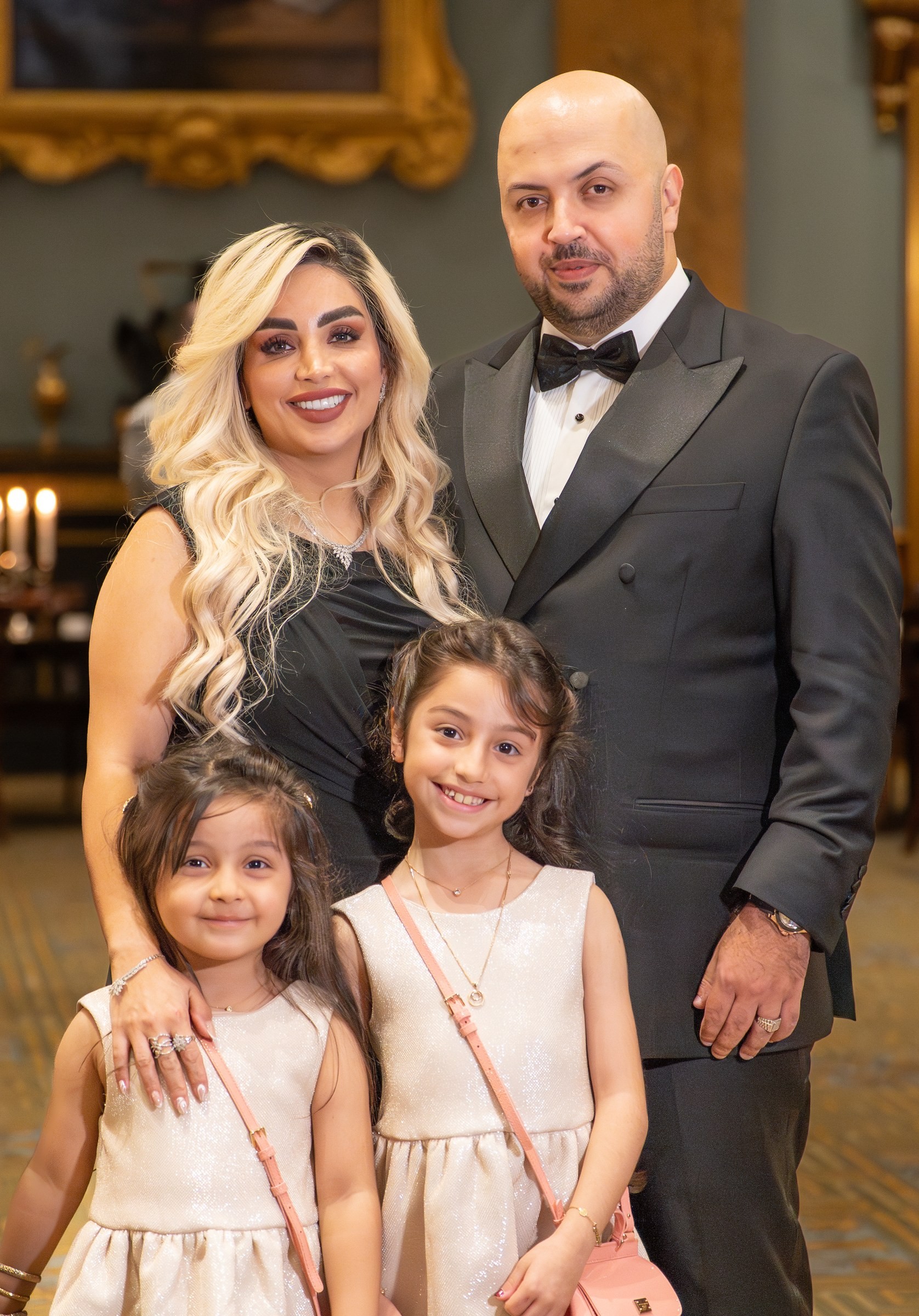 PORTRAITS · A family portrait at a gala dinner.