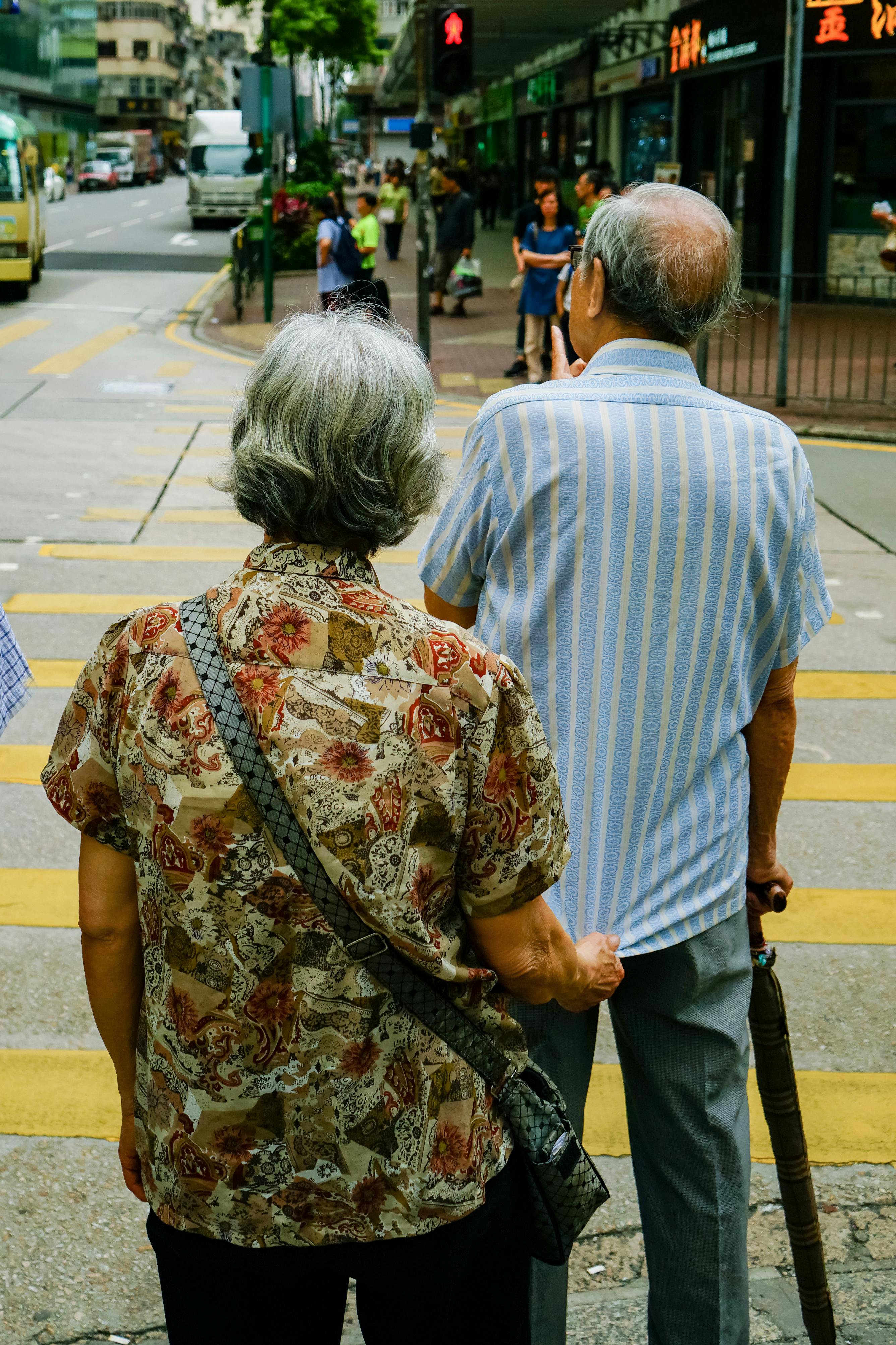 Elderly couple crossing the street