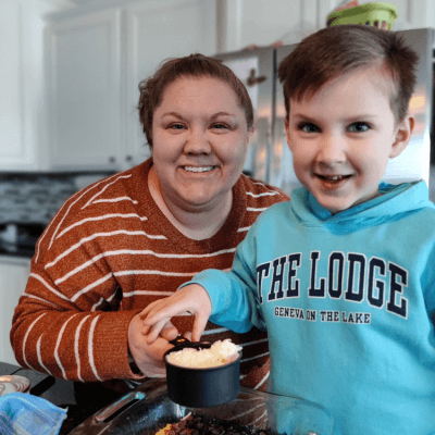 photo of theresea mayer and her son in kitchen smiling into the camera