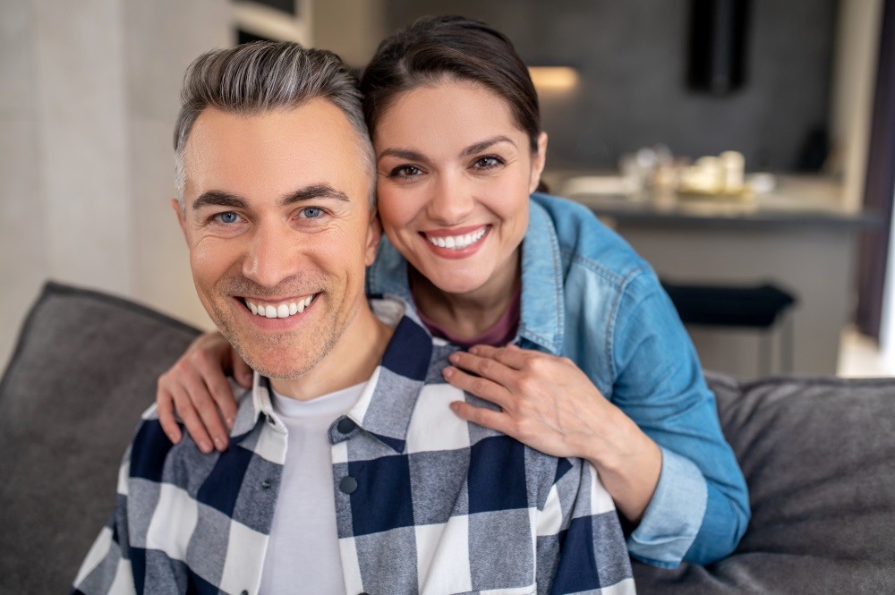 Smiling couple with dental implants