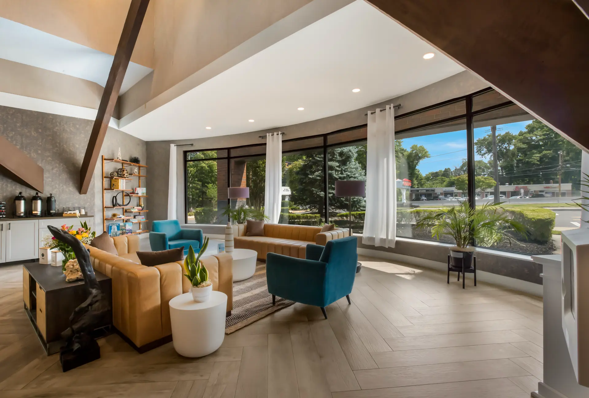 Modern living room interior with seating area and large windows.