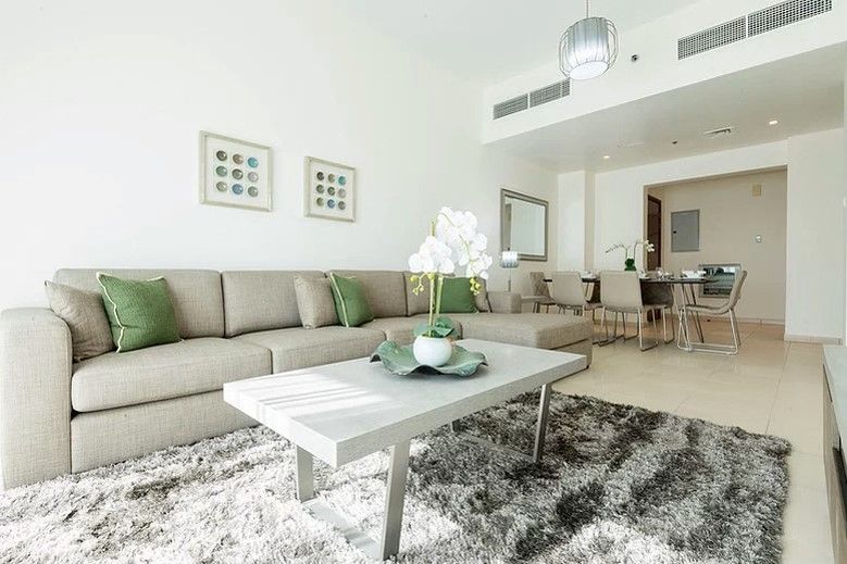 Contemporary open-plan interior featuring a stylish lounge area. Modern lifestyle apartments in Ajman.