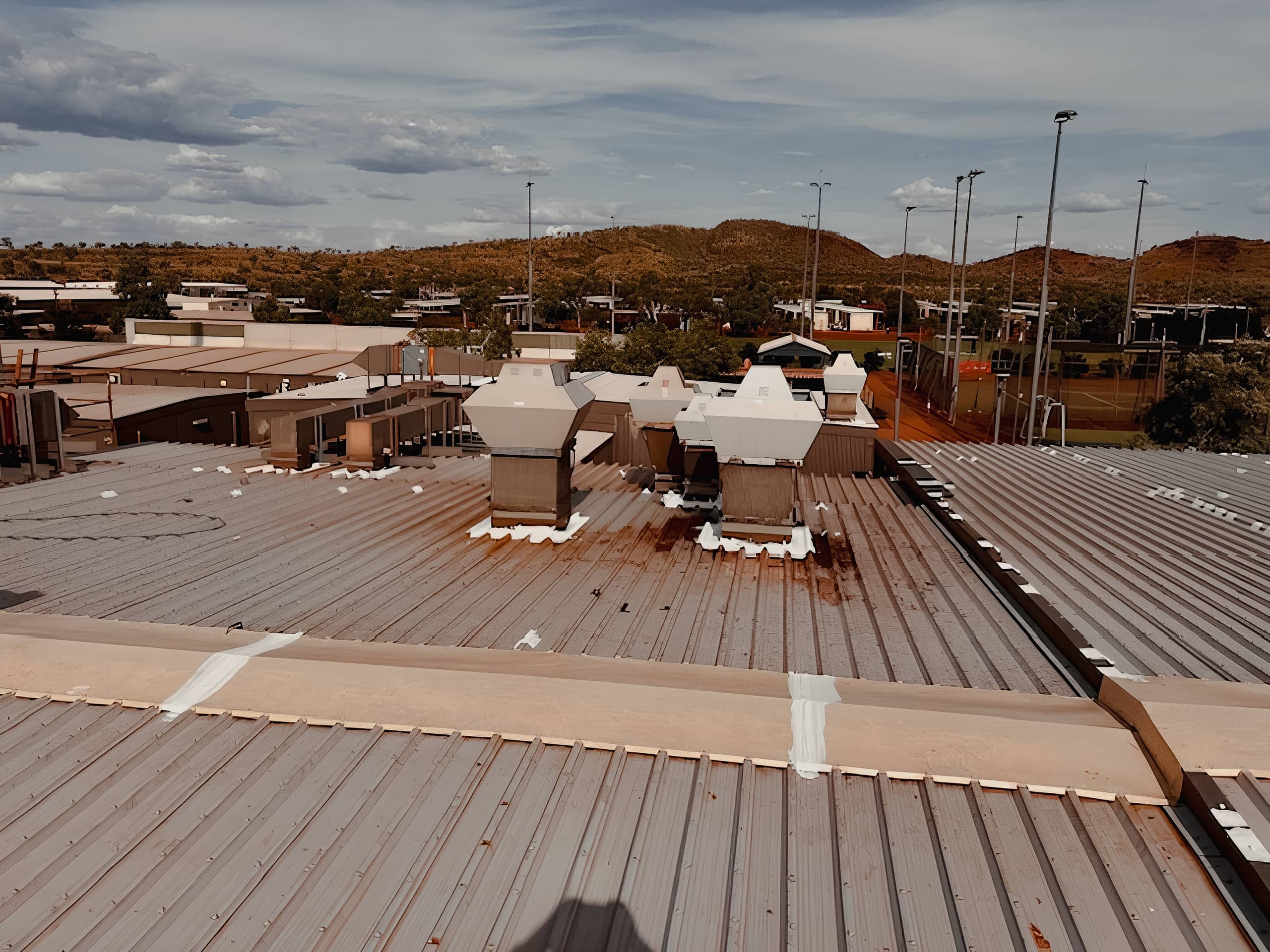 Industrial building roof with HVAC units in a remote, arid landscape