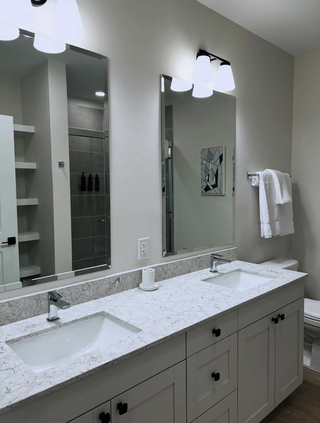 Airbnb bathroom vanity after turnover cleaning, featuring streak-free mirrors, polished marble countertops, and sanitized chrome fixtures.