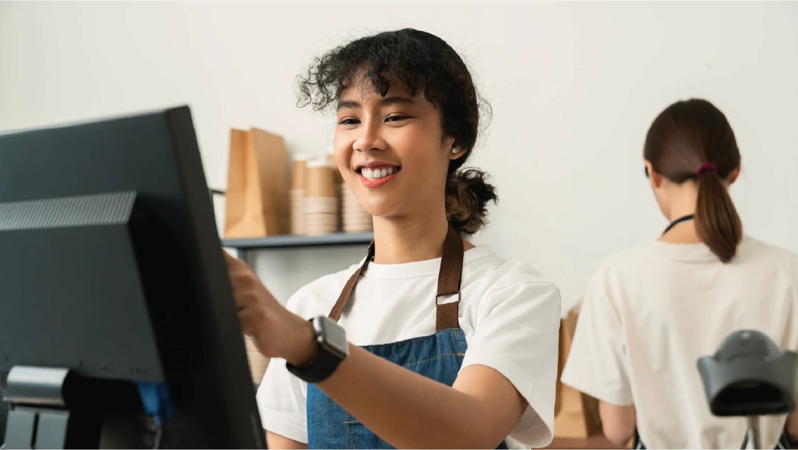Retail associate using a point-of-sale terminal on the store floor