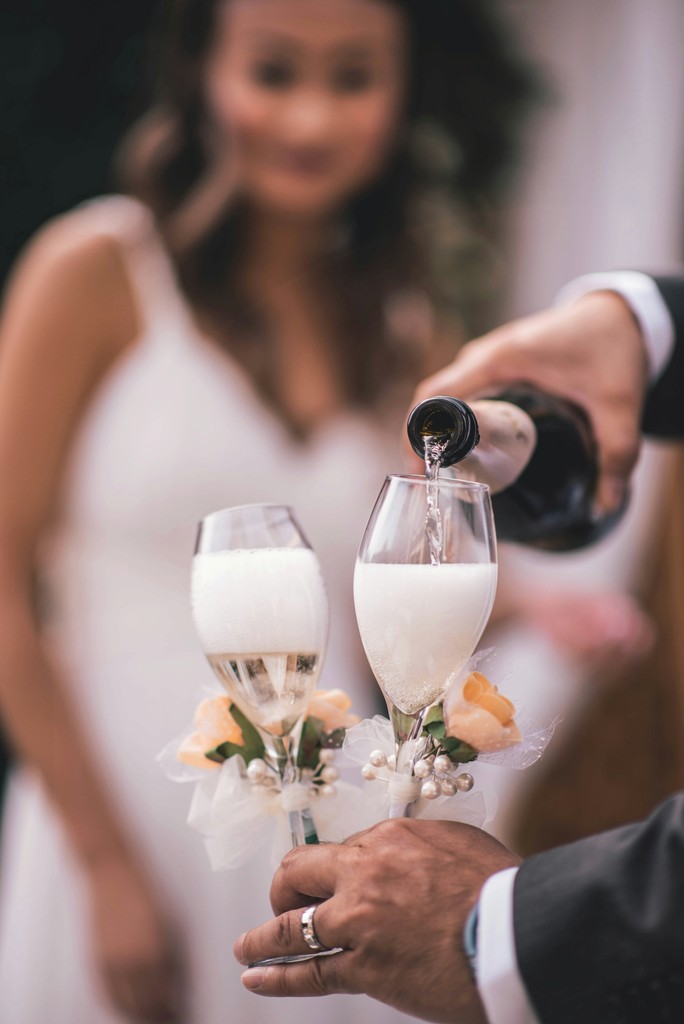 a couple of people that are holding wine glasses