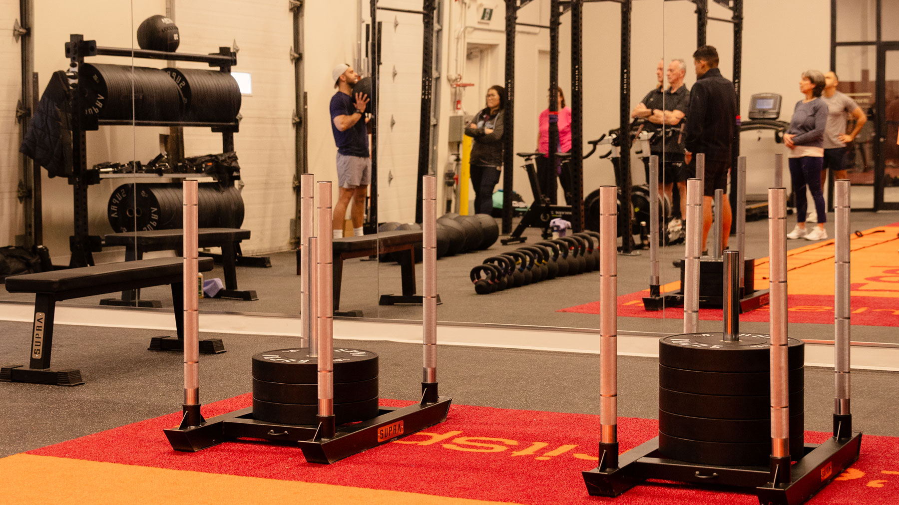 woman standing surrounded by exercise equipment
