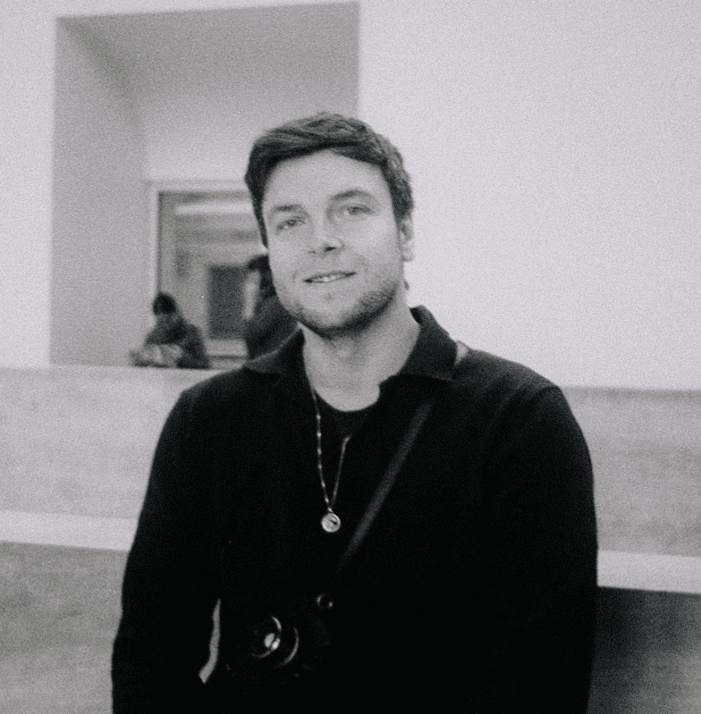 Man wearing white bunny hat with fake glasses and mustache design.
