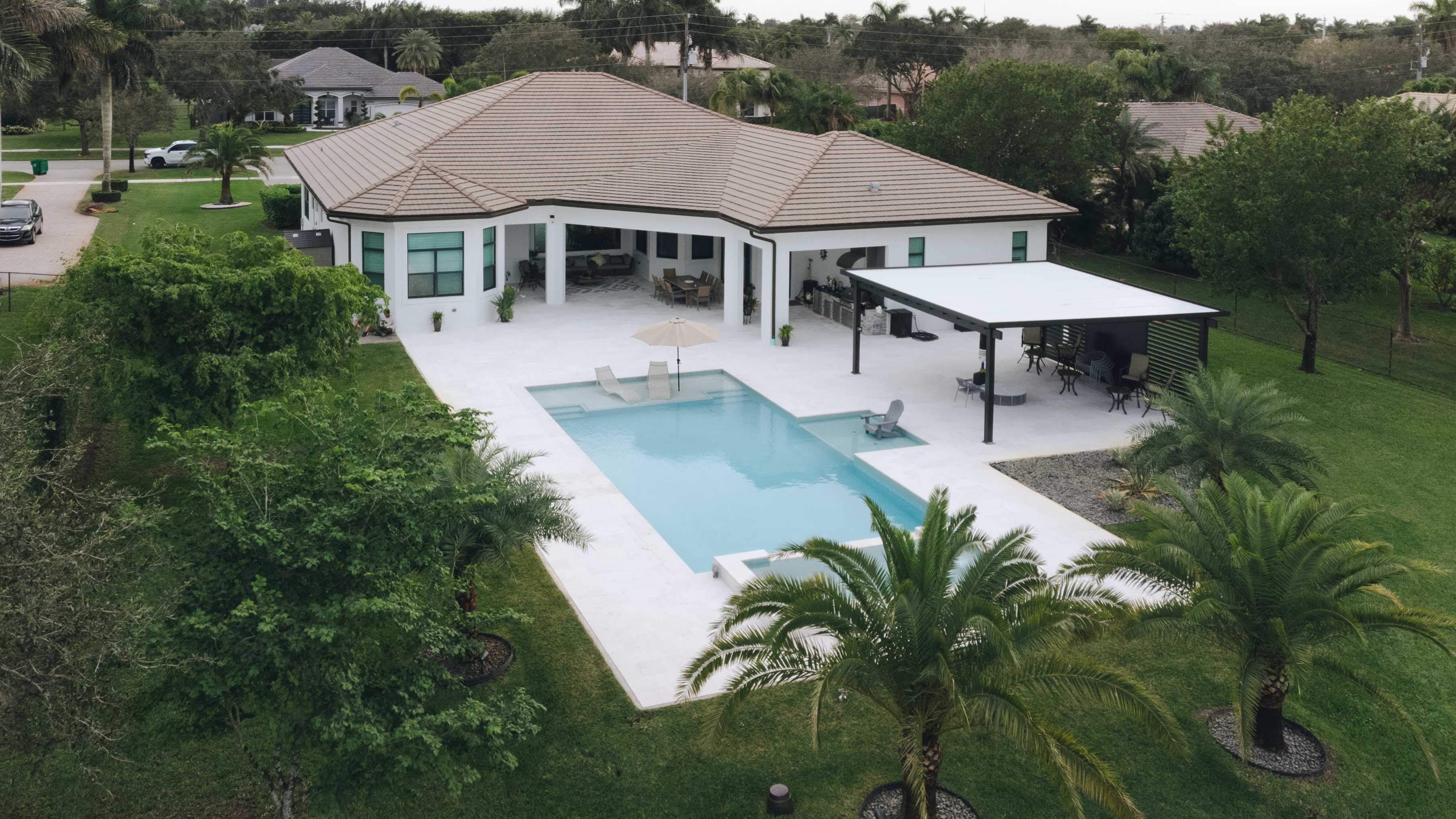 Spacious modern home with a large pool and covered patio.