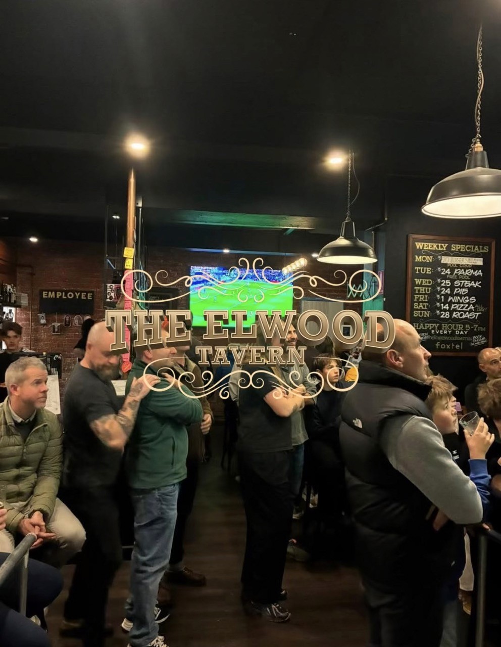 Busy Elwood Tavern crowd watching live sport inside the pub.