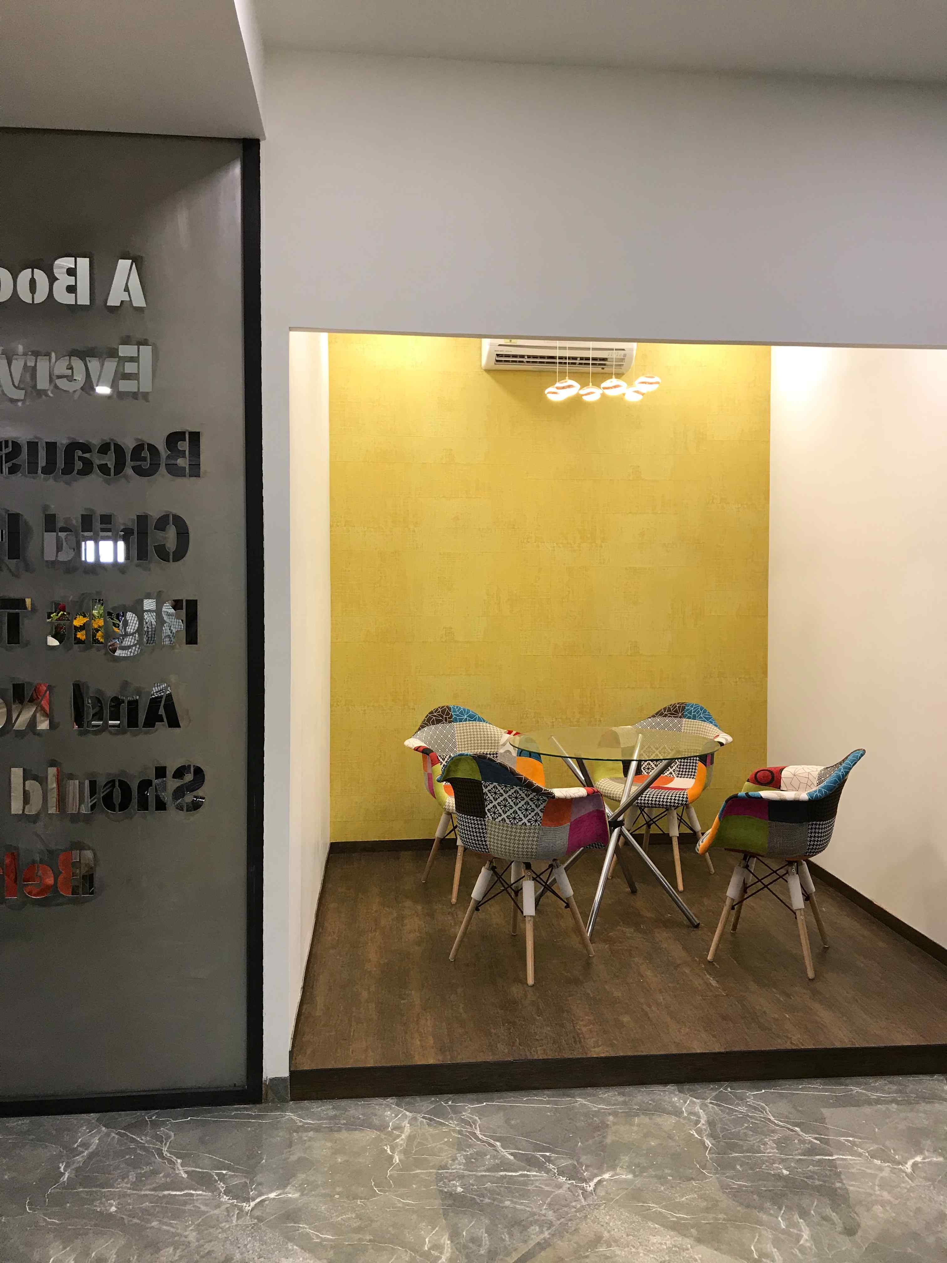 meeting room interior with yellow wall and round table in a publishing office