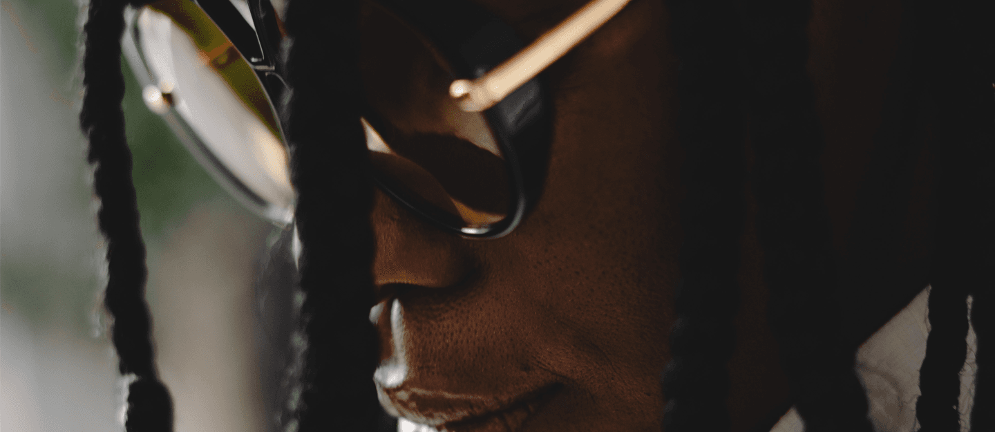 Zoomed in on Dali Adekunle with glasses and creative showcase of showcasing portfolio