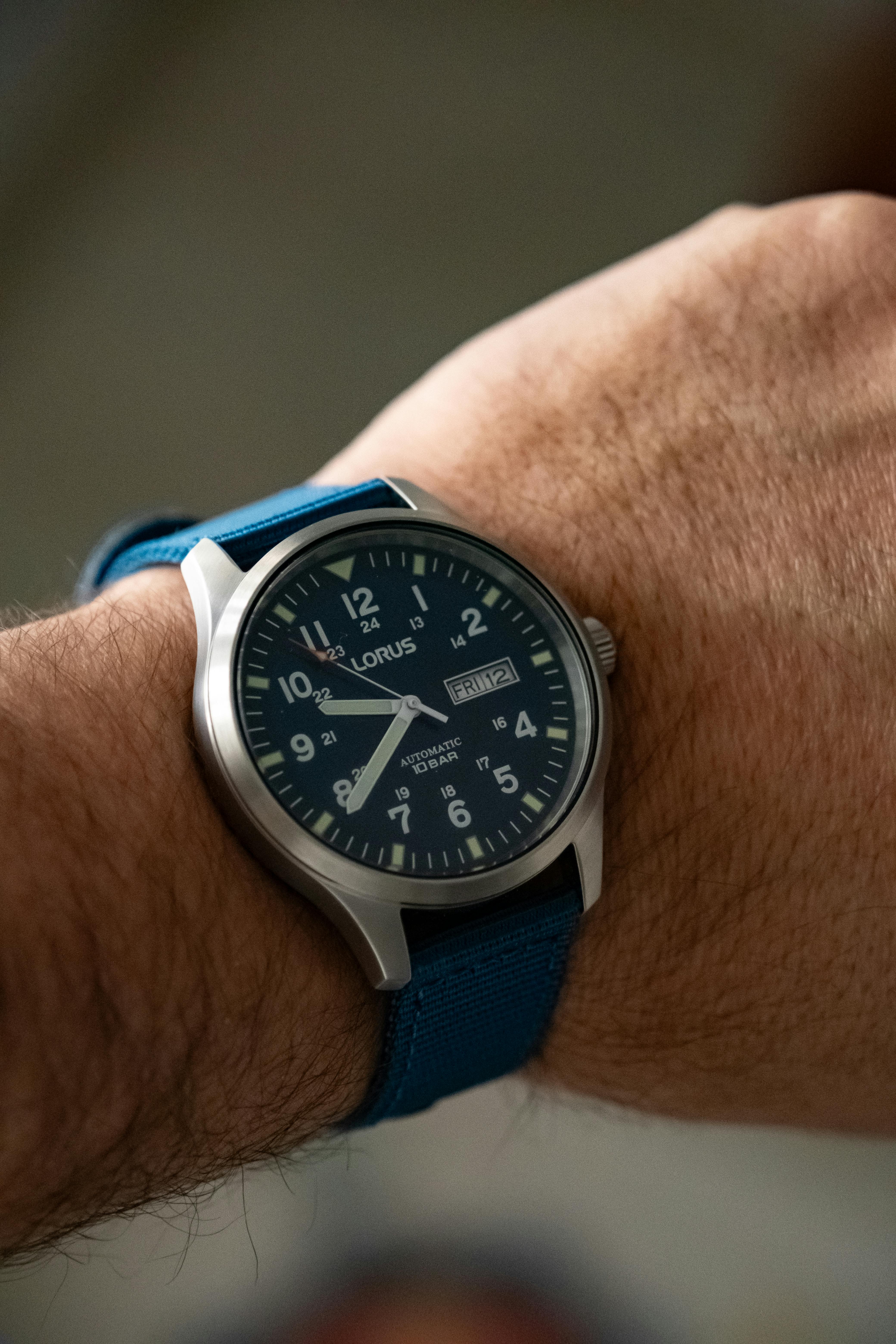Lorus watch on wearers wrist displaying field watch dial