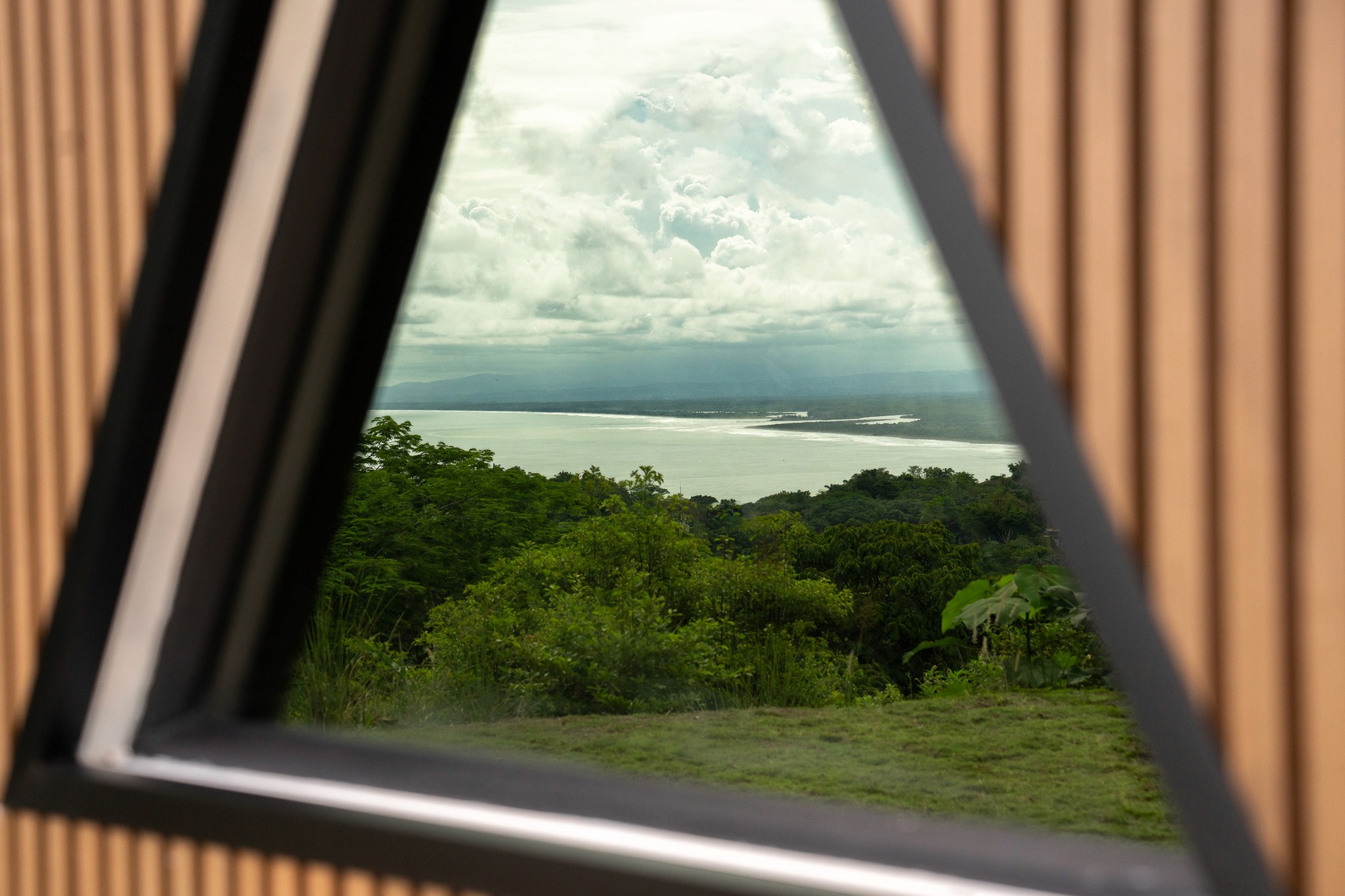 Private plunge pool and sun deck overlooking tropical gardens and an ocean sunset at the rental property.