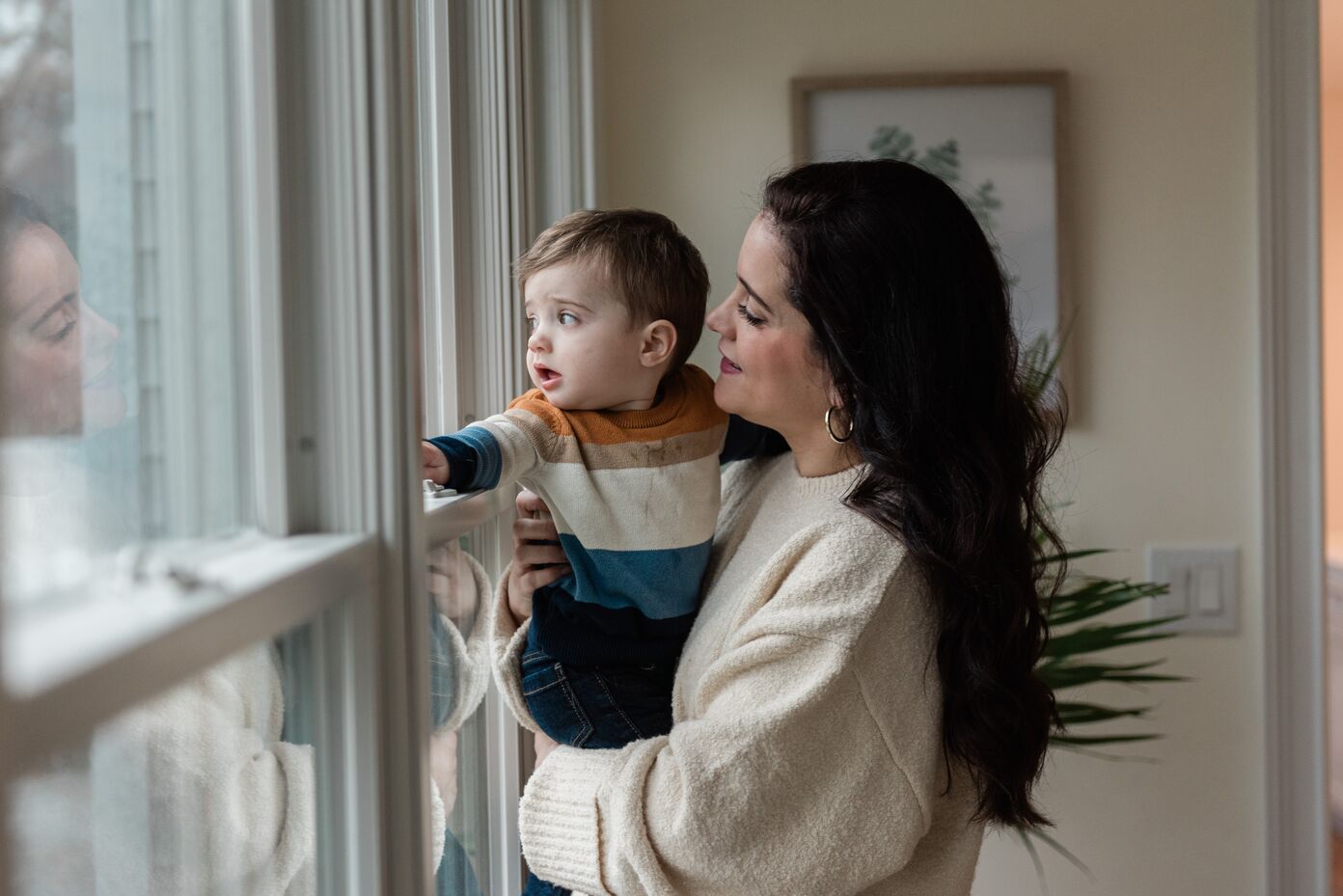 A mother and her son play next to a window during a prenatal and postpartum support therapy session in Dallas.