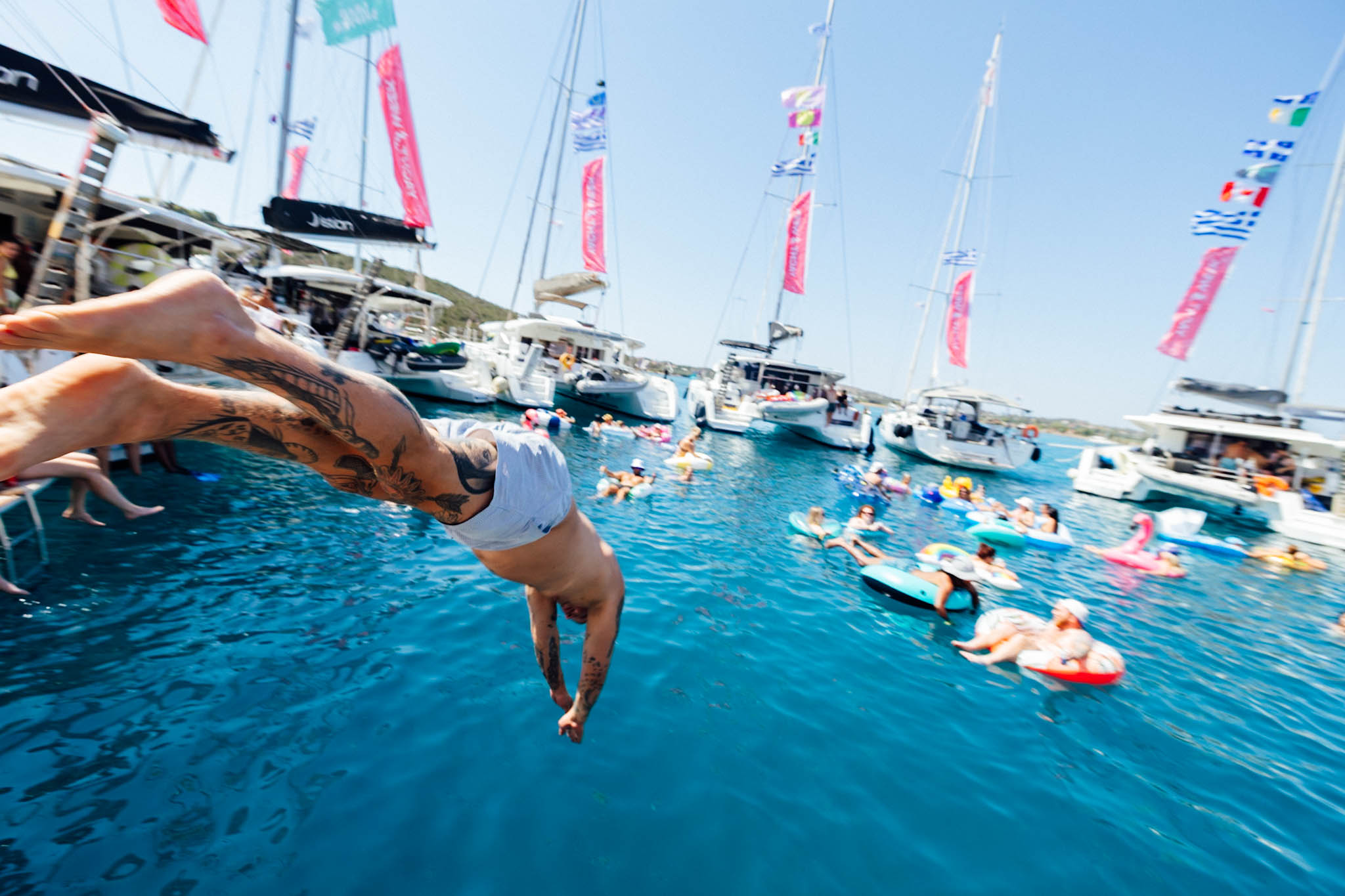 man diving in the water in the circle raft at Yacht Week 2025 in croatia