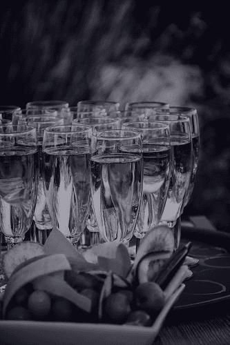 A serene pathway lined with trees leads to a distant building, bathed in warm sunlight.