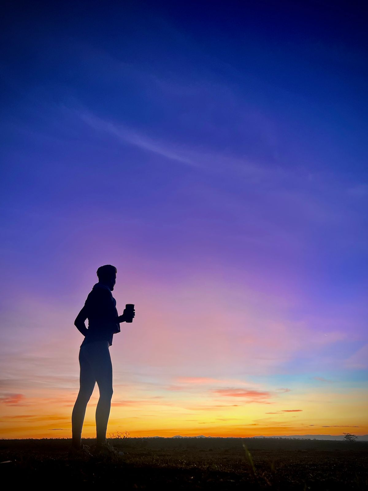 Black and white portrait of a smiling person with curly hair