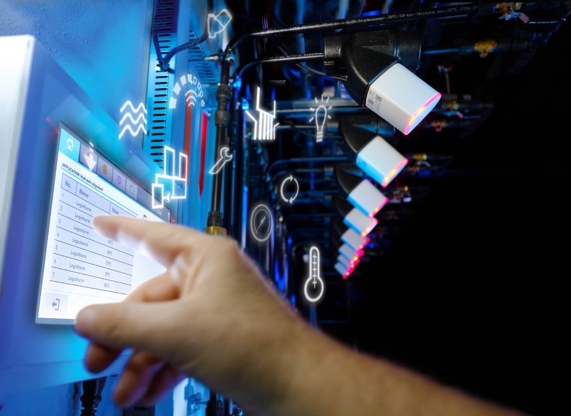A person touching a screen with sensors in the background