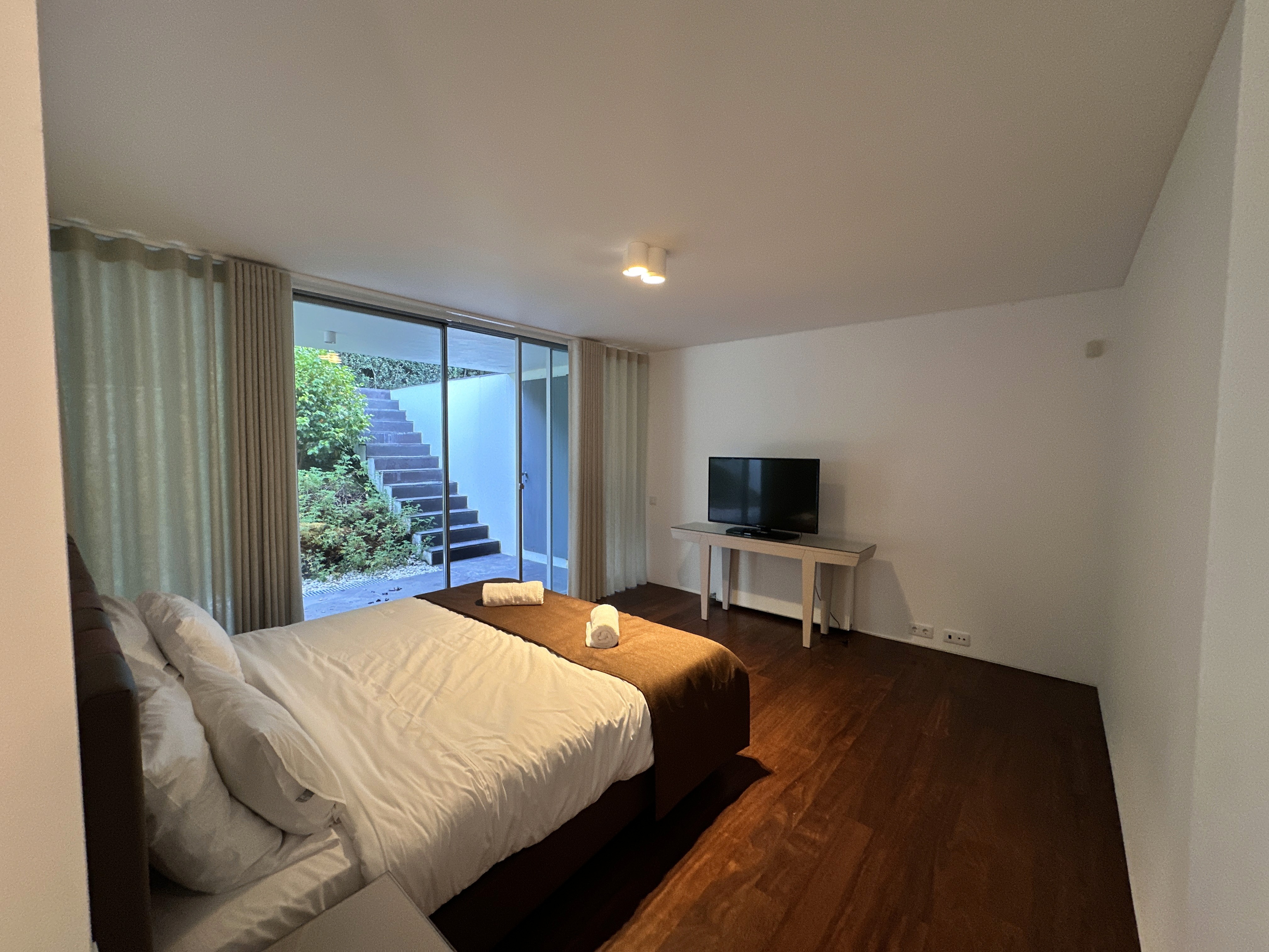 Bright bedroom with colorful bedspread and wall art