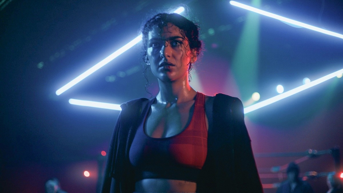 A boxer standing with lights in the background