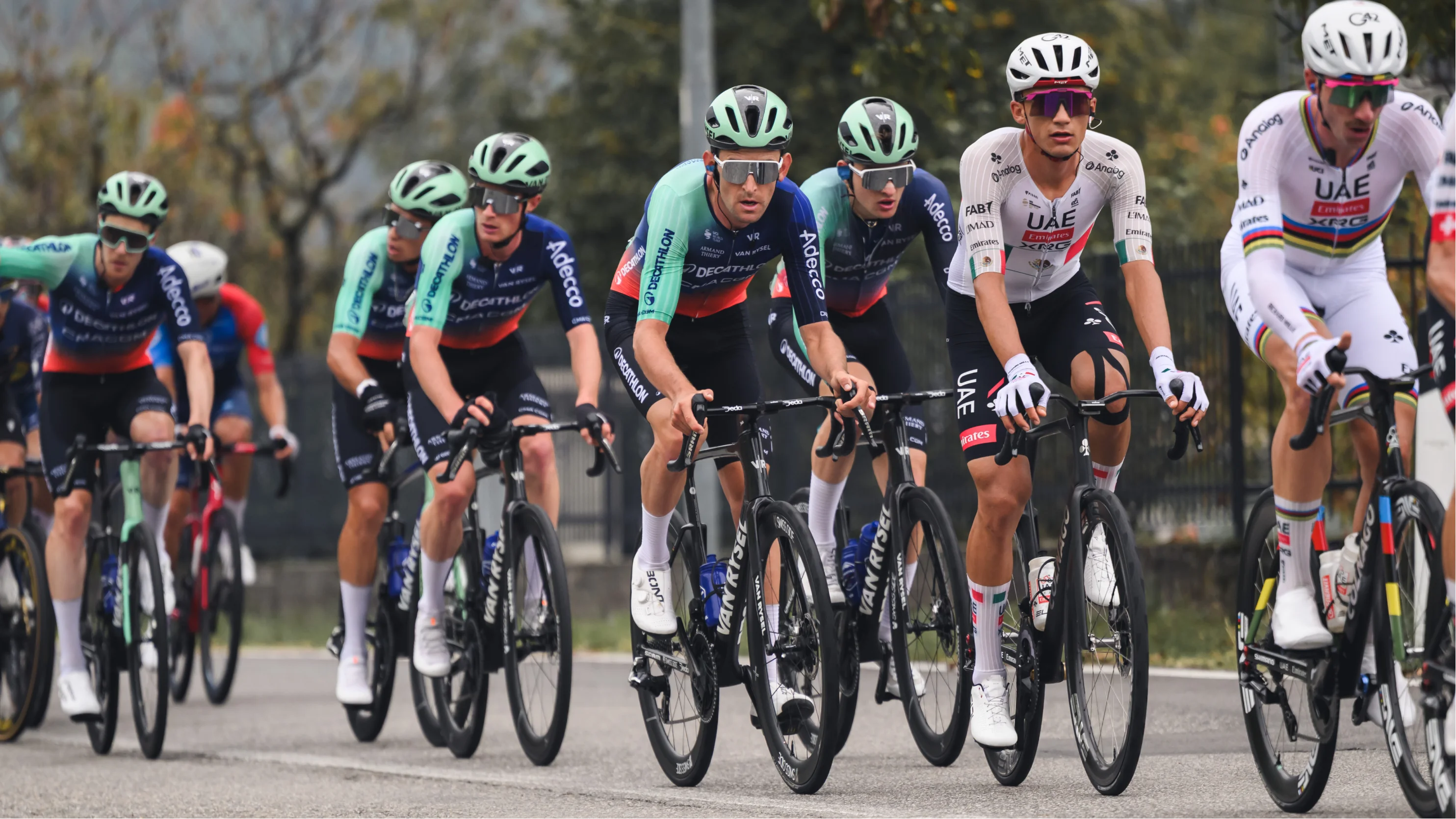 Decathlon CMA CGM riders in the peloton at Il Lombardia 2026, alongside UAE Team Emirates-XRG riders