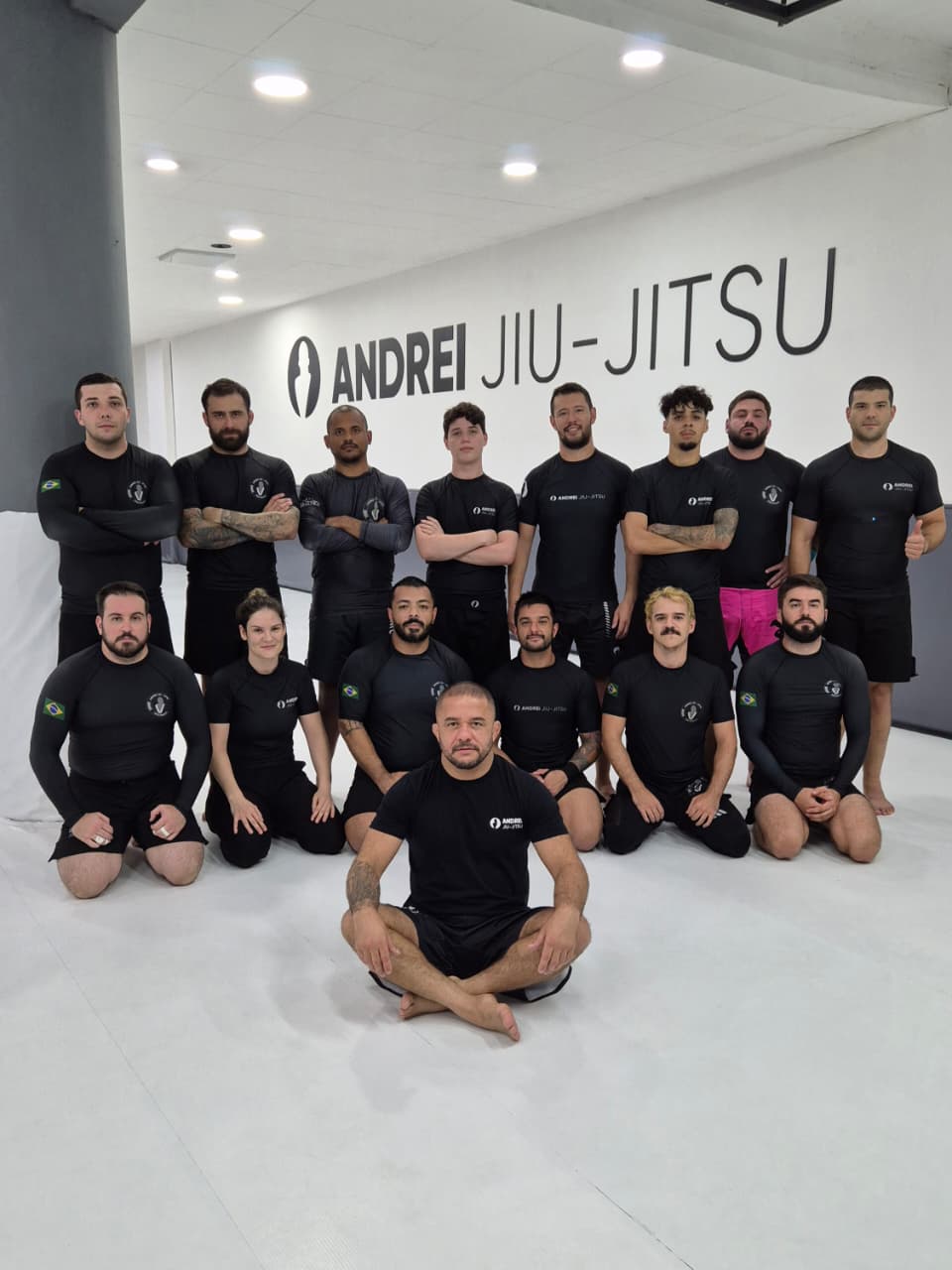 a man standing in a gym holding a rope