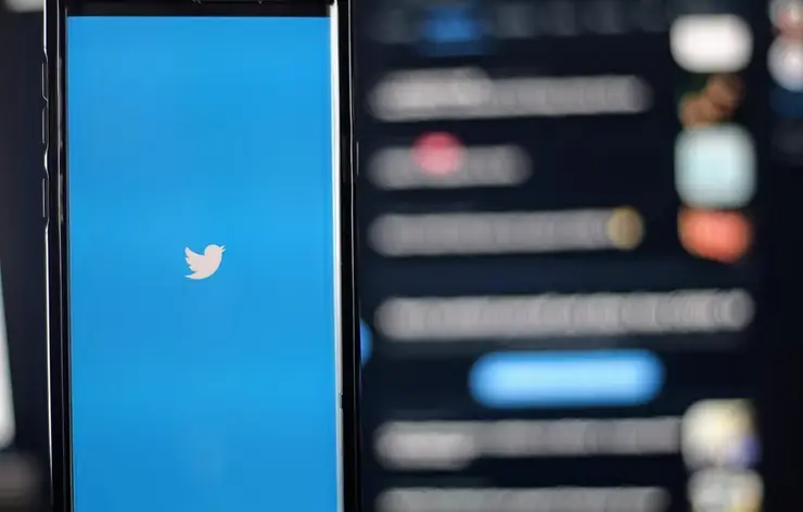 Smartphone displaying the Twitter app interface, representing social media communication and digital engagement.