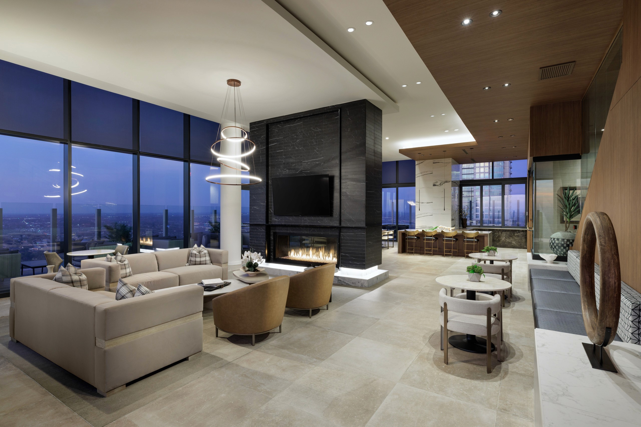 Modern lounge with fireplace and city view