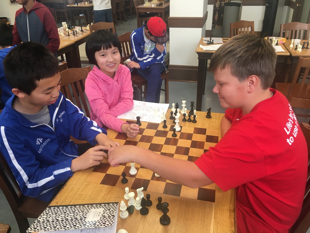 Smiling children playing chess