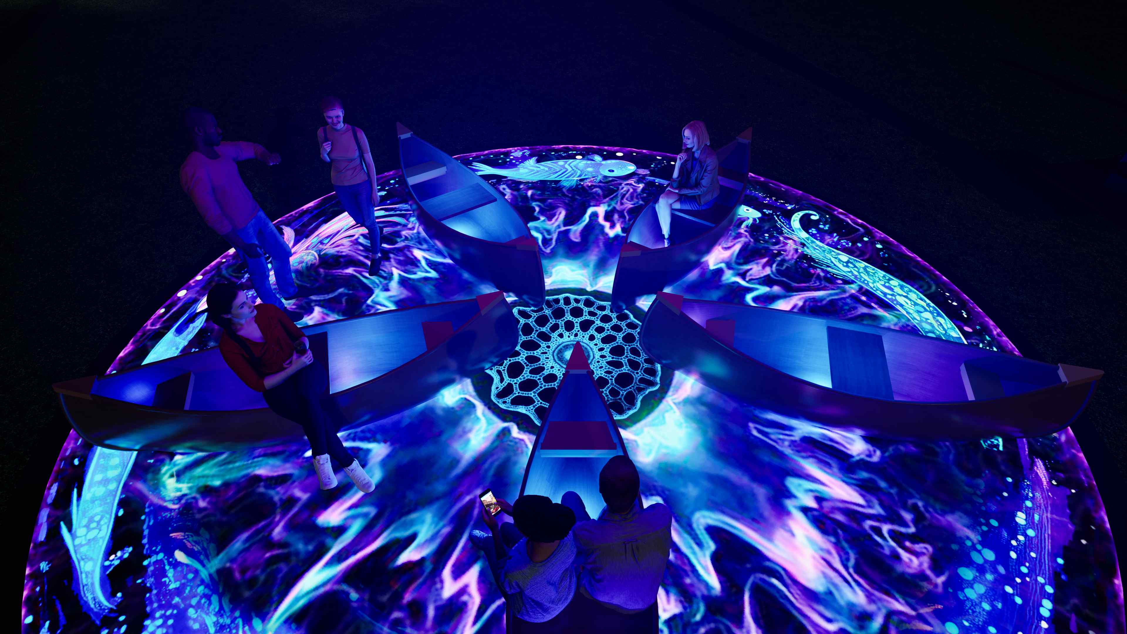 Interactive circular light installation at Vivid Sydney with participants engaging on illuminated platform and patterned projections