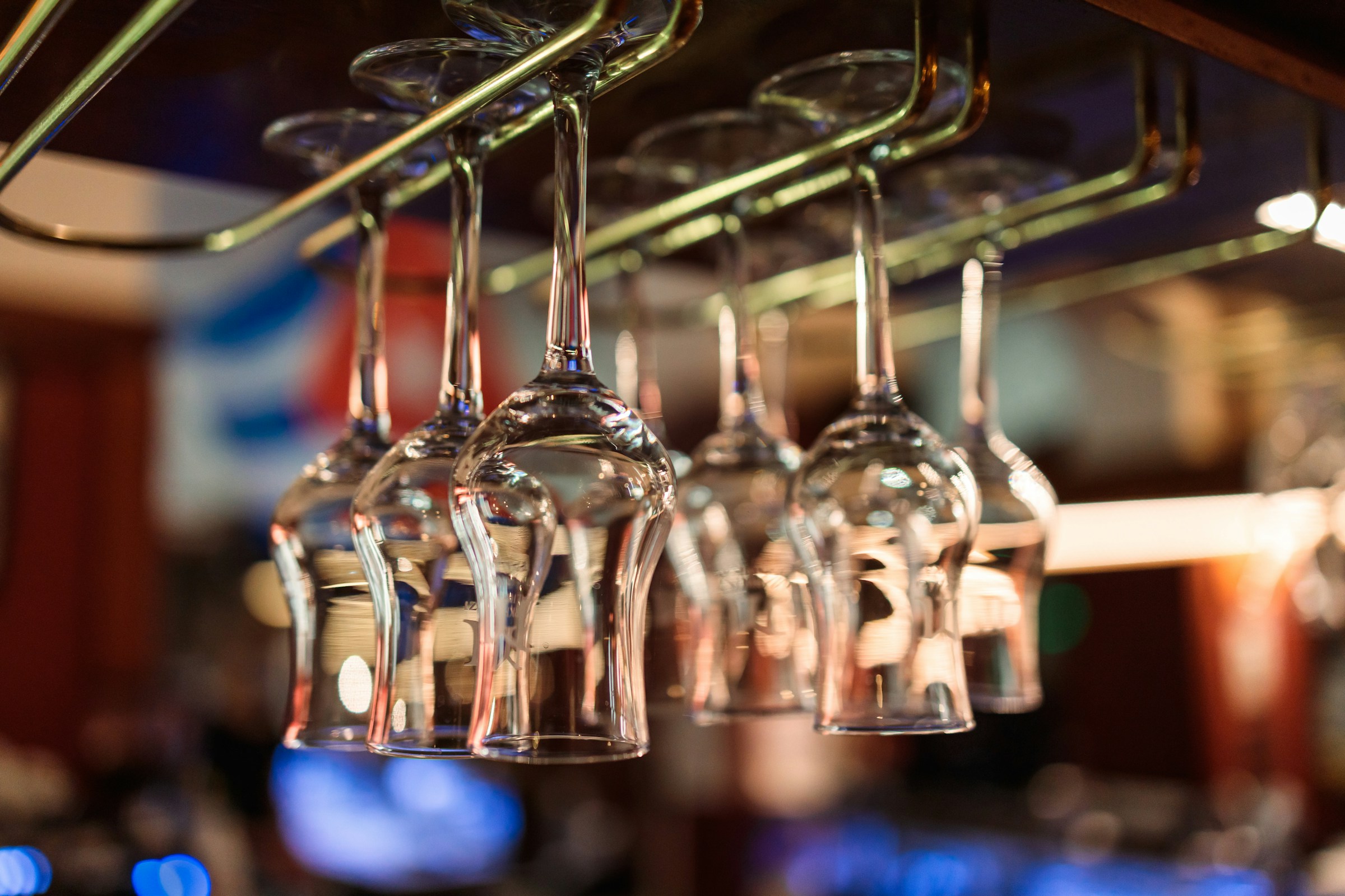 Wine glasses hanging above a bar