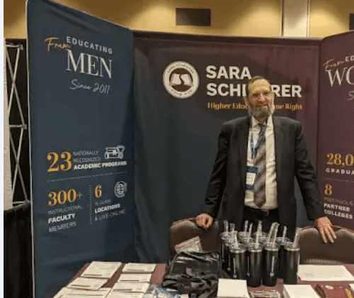 girl wearing grey long-sleeved shirt using MacBook Pro on brown wooden table