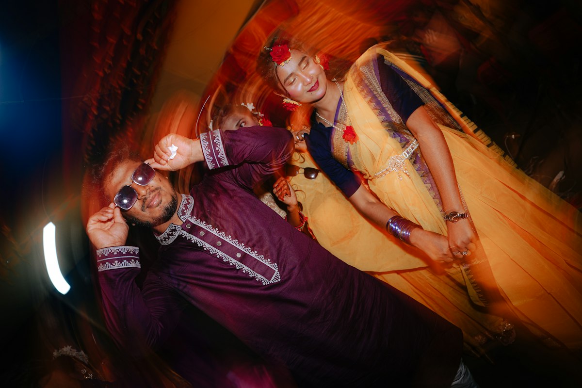 Bride and groom in traditional attire dancing together at their celebration