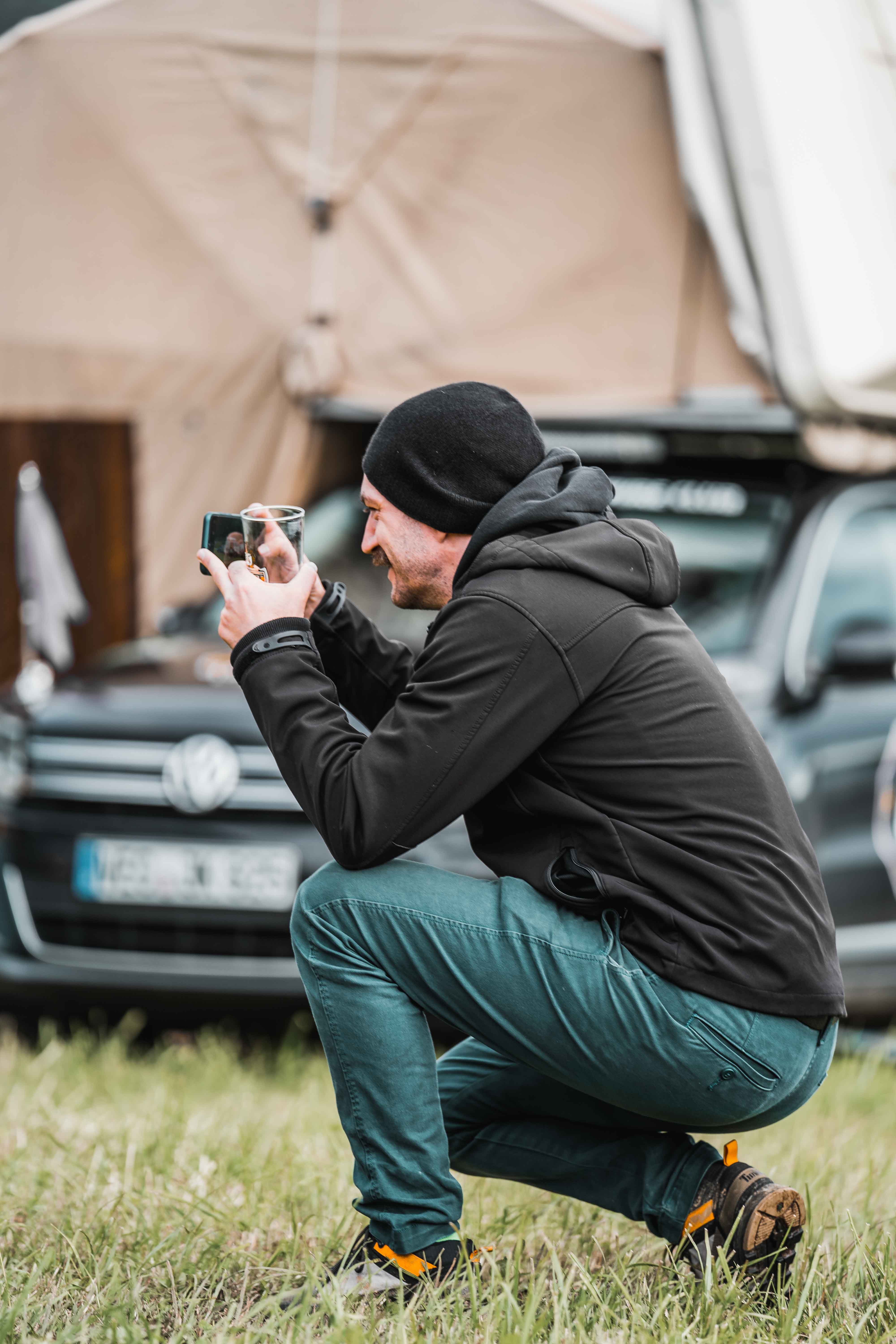 Camel caravan crossing vast golden dunes in AlUla, symbolizing traditional desert journeys.