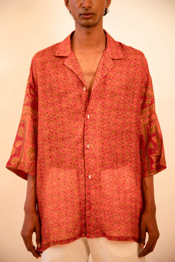 Oversized orange printed silk shirt handcrafted from a vintage sari, featuring a relaxed fit, 3/4 sleeves, soft texture, and playful button details, celebrating comfort, craft, and thoughtful design.