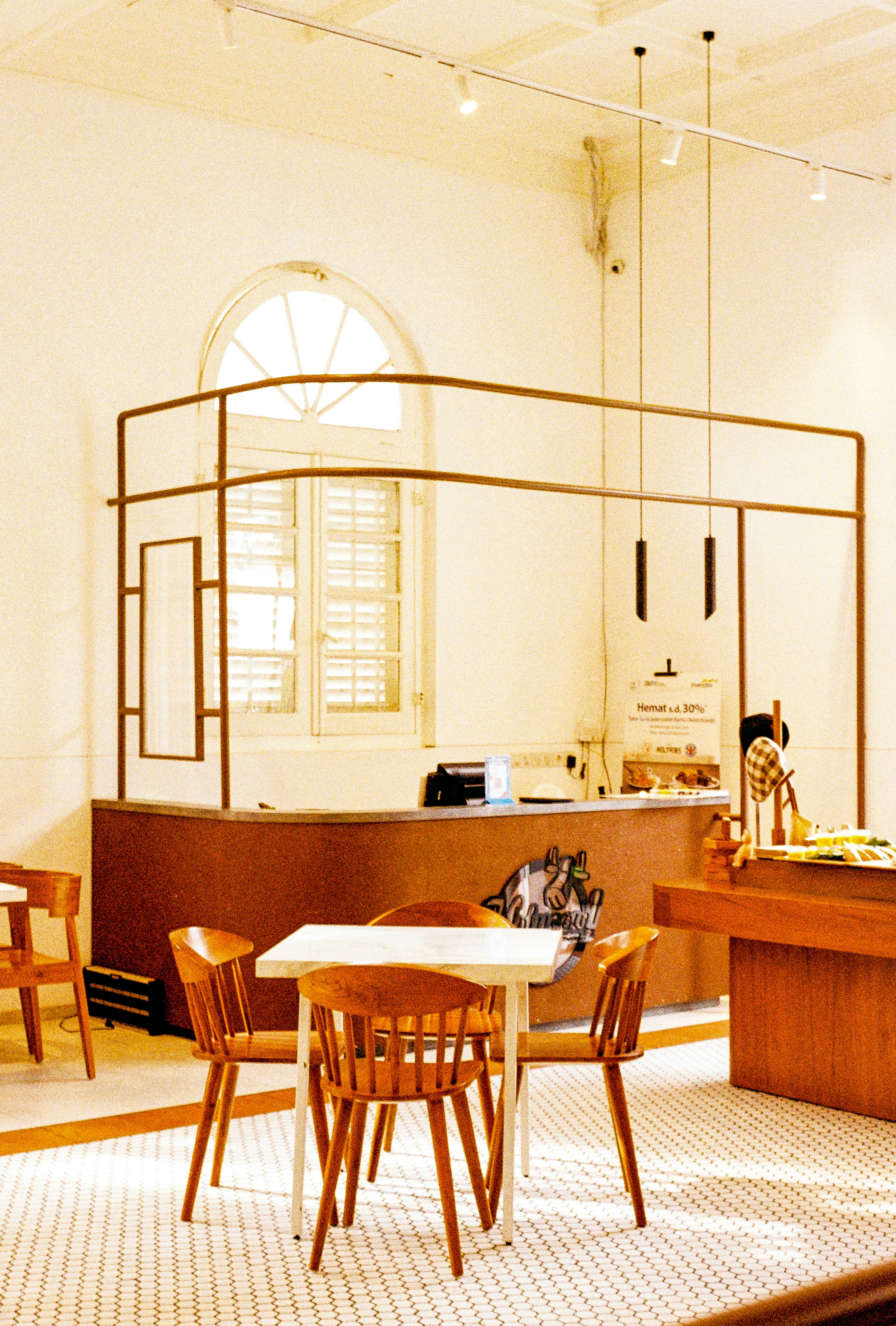 A room with a table, chairs, and a counter