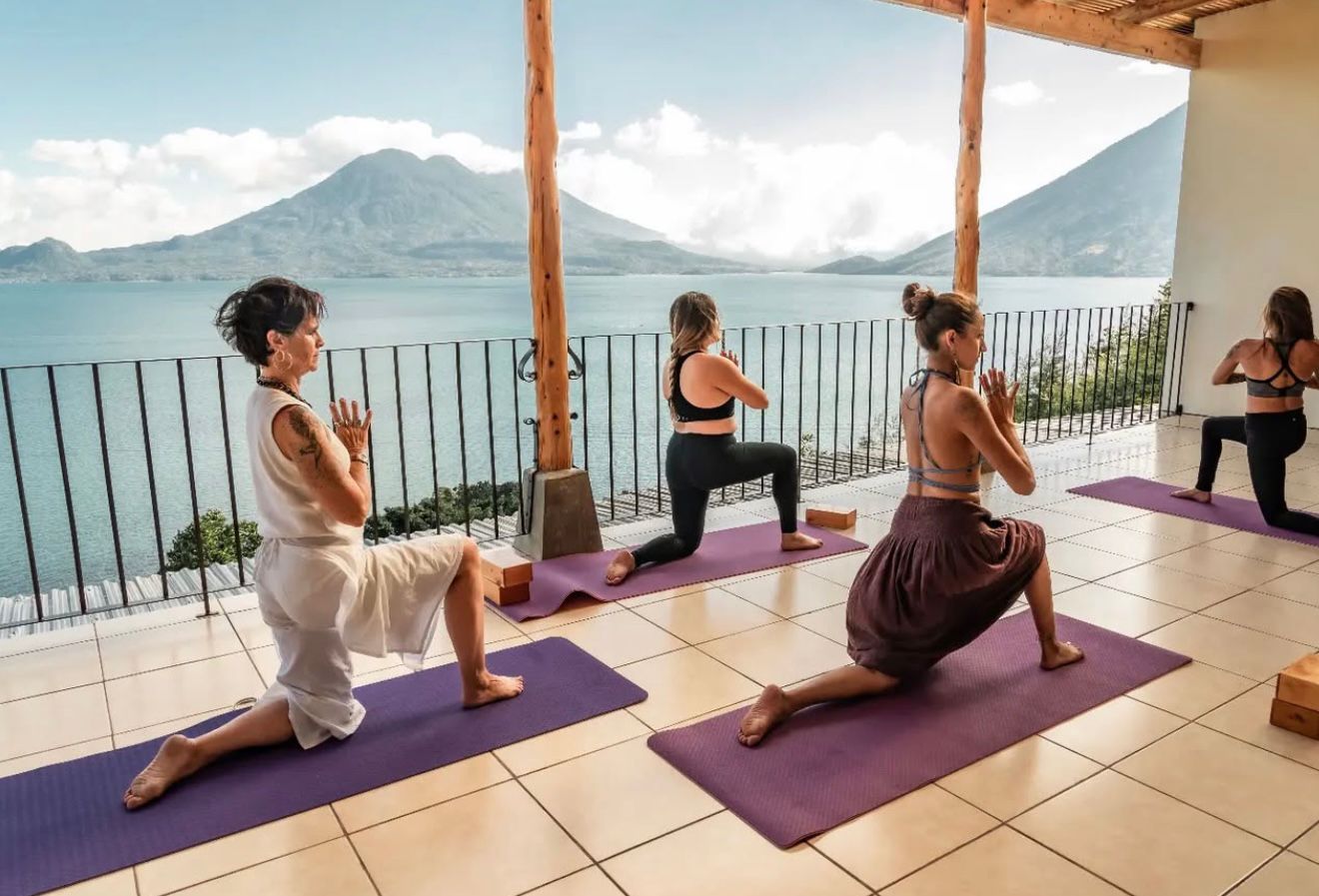 Retreat guests practicing movement on a deck