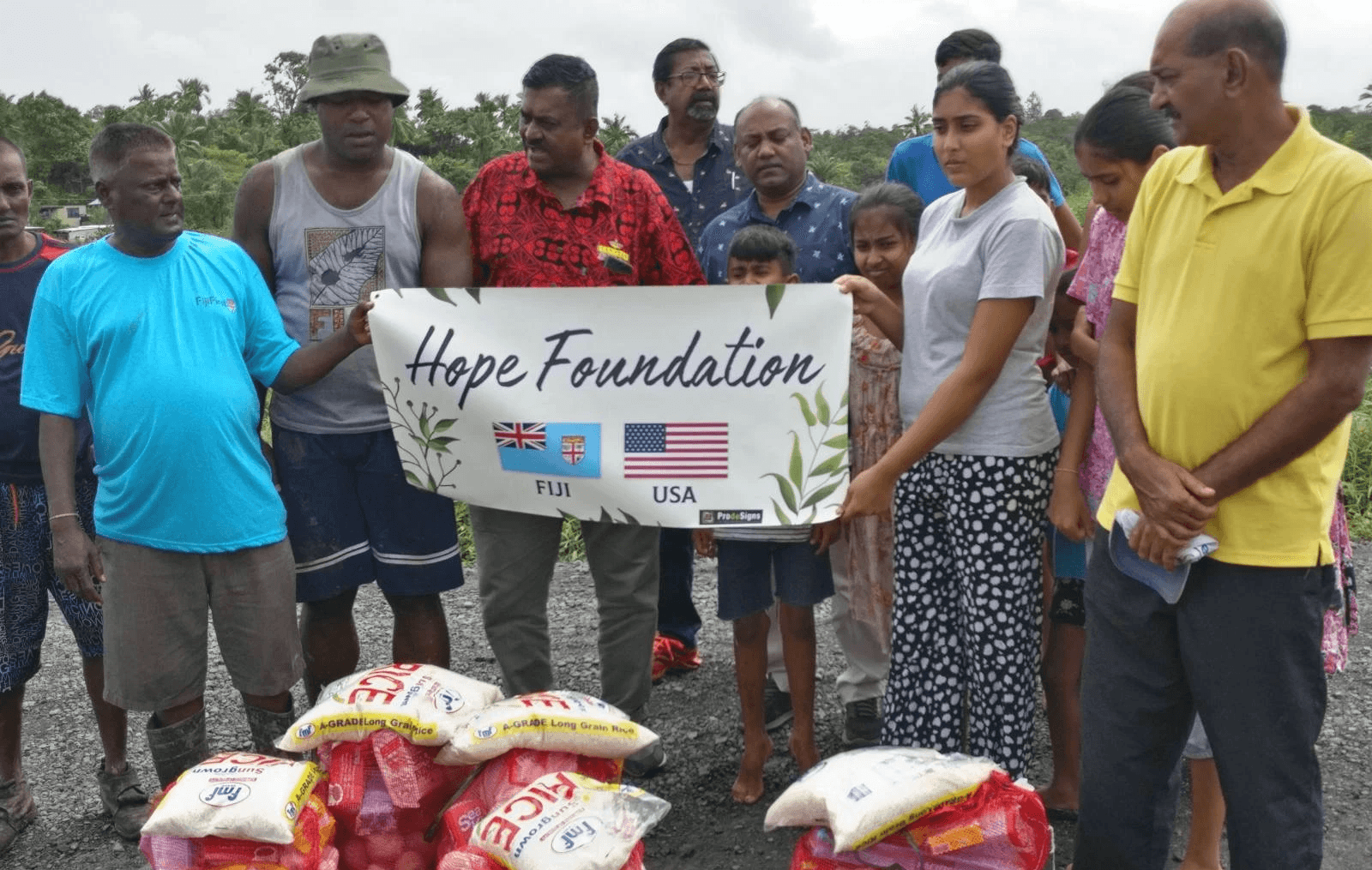 five children smiling while doing peace hand sign